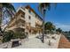 Exterior of a multi-story waterfront condo building, featuring balconies, landscaping, and an outdoor picnic area at 479 E Shore Dr # 8, Clearwater, FL 33767