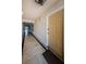 Long hallway with tiled floors and decorative wall sconces leading to condo units at 479 E Shore Dr # 8, Clearwater, FL 33767