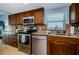 Close up view of kitchen, featuring modern stainless steel appliances, custom wood cabinets and granite countertops at 479 E Shore Dr # 8, Clearwater, FL 33767