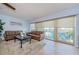 Cozy living room featuring comfortable seating, light blue walls and a view of the water at 479 E Shore Dr # 8, Clearwater, FL 33767