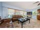 Inviting living room showcasing comfortable seating, a large TV, and a view of the outdoors at 479 E Shore Dr # 8, Clearwater, FL 33767