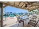 Covered outdoor dining area featuring a table with seating and waterfront views of the harbor and boat docks at 479 E Shore Dr # 8, Clearwater, FL 33767