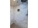 Shower featuring neutral tile, a mounted showerhead, and practical storage options at 479 E Shore Dr # 8, Clearwater, FL 33767