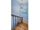Stylish staircase featuring wood steps, wrought iron railing and modern light fixture at 479 E Shore Dr # 8, Clearwater, FL 33767