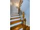 Staircase with wood steps and detailed wrought iron railing that leads to the upper floors of the residence at 479 E Shore Dr # 8, Clearwater, FL 33767