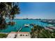 Stunning waterfront view framed by palm trees, showcasing the turquoise water and surrounding cityscape at 479 E Shore Dr # 8, Clearwater, FL 33767