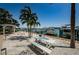 Lush waterfront patio and entertainment area with a picnic table, seating, and views of the harbor at 479 E Shore Dr # 8, Clearwater, FL 33767