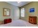 Cozy bedroom with neutral carpet, complemented by natural light from a window and a spacious closet at 501 Pinewood Dr, Oldsmar, FL 34677