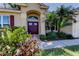 Close-up of entryway featuring lush landscaping and a beautiful front door at 501 Pinewood Dr, Oldsmar, FL 34677