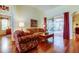 Living room with hardwood floors and a view of the screened-in pool at 501 Pinewood Dr, Oldsmar, FL 34677