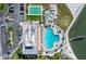 Overhead view of community pool, lounge chairs, shuffleboard, grilling area, boat dock, and parking at 5220 Brittany S Dr # 309, St Petersburg, FL 33715