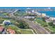 Picturesque aerial view showcases the waterfront property with lush golf course, highway and nearby hotels at 5220 Brittany S Dr # 309, St Petersburg, FL 33715