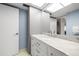 Well-lit bathroom features a marble countertop, modern sink, and storage cabinets at 5220 Brittany S Dr # 309, St Petersburg, FL 33715