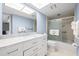 Bathroom with a marble countertop, modern sink, and glass-enclosed shower with built-in seating at 5220 Brittany S Dr # 309, St Petersburg, FL 33715