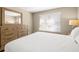 Comfortable bedroom featuring wood dresser and natural light from the bright window at 5220 Brittany S Dr # 309, St Petersburg, FL 33715