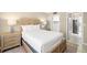 Cozy bedroom offering a queen bed, nightstands, and an ensuite bathroom in neutral tones at 5220 Brittany S Dr # 309, St Petersburg, FL 33715