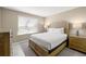 Bedroom with natural light features a bed with white comforter, wooden furniture, and neutral decor at 5220 Brittany S Dr # 309, St Petersburg, FL 33715