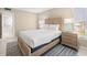 Bright bedroom features a wood bed frame, a blue patterned rug, and an ensuite bathroom at 5220 Brittany S Dr # 309, St Petersburg, FL 33715