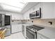 Updated kitchen featuring stainless steel appliances and quartz countertops at 5220 Brittany S Dr # 309, St Petersburg, FL 33715