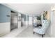 Well-lit lobby with elevators, seating, and contemporary decor for a welcoming atmosphere at 5220 Brittany S Dr # 309, St Petersburg, FL 33715