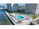Beautiful waterfront condominium featuring an in-ground pool, palm trees, and waterfront views at 5220 Brittany S Dr # 309, St Petersburg, FL 33715