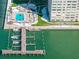 Inviting community pool features lounge area, tiki bar, boat docks and bay access from above at 5220 Brittany S Dr # 309, St Petersburg, FL 33715