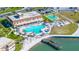 Community pool featuring a spacious deck with lounge chairs, umbrellas and a fishing pier on the water at 5220 Brittany S Dr # 309, St Petersburg, FL 33715