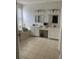 Elegant bathroom featuring double sinks, granite countertops, tile flooring, and a luxurious soaking tub for relaxation at 5229 Clover Mist Dr, Apollo Beach, FL 33572