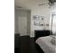 Inviting bedroom features dark wood floors, black dresser, and neutral decor, creating a peaceful and relaxing atmosphere at 5229 Clover Mist Dr, Apollo Beach, FL 33572