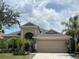 Charming single-story home featuring a well-maintained lawn and a spacious two-car garage at 5229 Clover Mist Dr, Apollo Beach, FL 33572