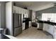 Bright kitchen with stainless steel appliances, white cabinets, and tile flooring at 5229 Clover Mist Dr, Apollo Beach, FL 33572