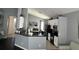 Modern kitchen featuring white cabinets, stainless steel appliances, and black countertops at 5229 Clover Mist Dr, Apollo Beach, FL 33572