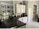 Kitchen area with granite countertops, white cabinetry, stainless steel sink, and modern appliances, perfect for cooking at 5229 Clover Mist Dr, Apollo Beach, FL 33572