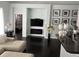 Stylish living room with dark wood floors, modern TV setup, and elegant decor, creating a cozy and inviting space at 5229 Clover Mist Dr, Apollo Beach, FL 33572