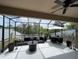 Spacious screened patio with outdoor seating and ceiling fan, ideal for relaxation and gatherings at 5229 Clover Mist Dr, Apollo Beach, FL 33572