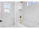 Bathroom featuring white tiled shower and gold hardware at 5337 6Th N Ave, St Petersburg, FL 33710