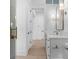 Hallway bathroom with white marble countertops, gold hardware, and modern light fixtures at 5337 6Th N Ave, St Petersburg, FL 33710