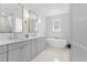 Bright bathroom with dual vanities, a freestanding tub, and stylish fixtures at 5337 6Th N Ave, St Petersburg, FL 33710