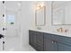 Modern bathroom featuring double vanity with gray cabinets, gold hardware, and mosaic tile flooring at 5337 6Th N Ave, St Petersburg, FL 33710