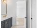 Modern bathroom featuring single vanity with gray cabinets, gold hardware, and mosaic tile flooring at 5337 6Th N Ave, St Petersburg, FL 33710