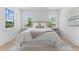 Cozy bedroom with a plush bed, decorative pillows, and natural light streaming through the windows at 5337 6Th N Ave, St Petersburg, FL 33710
