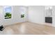 Bright bedroom featuring hardwood floors and two windows allowing natural light and an adjacent bathroom at 5337 6Th N Ave, St Petersburg, FL 33710