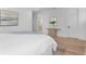 Stylish bedroom with light wood floors and a glimpse into the luxurious bathroom at 5337 6Th N Ave, St Petersburg, FL 33710