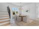 Dining room with a wood table, seating for six, a gold chandelier, and stairs to the second floor at 5337 6Th N Ave, St Petersburg, FL 33710