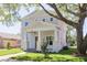 Beautiful two-story home featuring a light gray exterior, covered front porch, and mature landscaping at 5337 6Th N Ave, St Petersburg, FL 33710