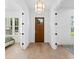 Bright foyer featuring hardwood floors, white trim, paneled doors, and decorative lighting at 5337 6Th N Ave, St Petersburg, FL 33710