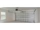Bright garage interior featuring a metal garage door, concrete floor, and a small window at 5337 6Th N Ave, St Petersburg, FL 33710