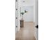 Bright hallway features light wood floors, white walls, and stylish table with vase at 5337 6Th N Ave, St Petersburg, FL 33710