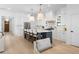 A kitchen with stainless appliances, a large island with seating and quartz countertop, and modern pendant lighting at 5337 6Th N Ave, St Petersburg, FL 33710