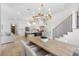 Bright, open-concept kitchen with island, modern appliances, and adjacent dining area with striking gold chandelier at 5337 6Th N Ave, St Petersburg, FL 33710
